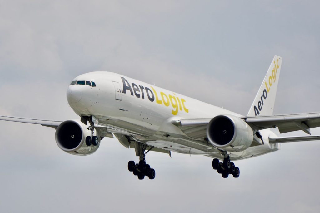 Cargo aircraft in flight against a cloudy sky