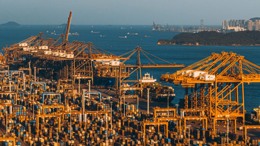 Yellow cargo cranes and containers at an ocean port
